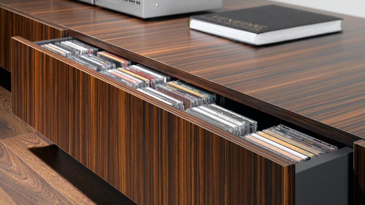 Detailaufnahme eines lackierten Sideboards mit offener Schublade für CD-Aufbewahrung